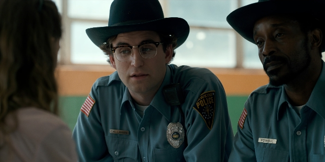 Medium shot frame from Stranger Things — sitting, room, table