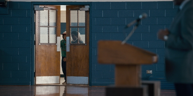 Wide shot frame from Stranger Things — standing, room, door