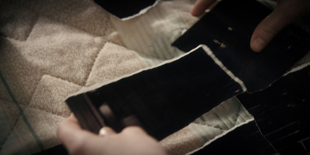 Wide shot frame from Stranger Things — room, bed, hand