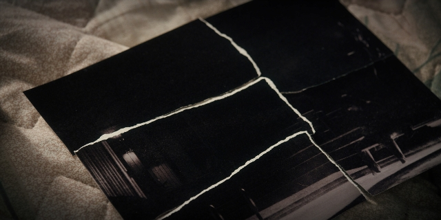 Wide shot frame from Stranger Things — book, bed, window