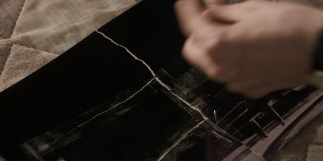 Wide shot frame from Stranger Things — hand, person, human hand