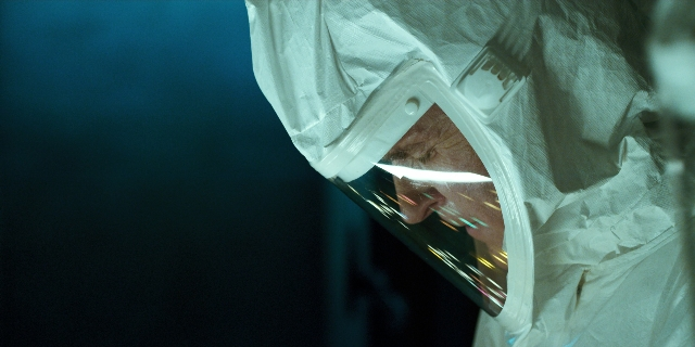 Wide shot frame from Stranger Things — hat, suit, face
