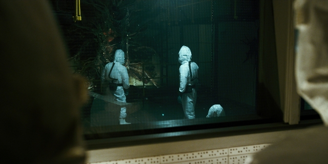 Wide shot frame from Stranger Things — standing, room, glass
