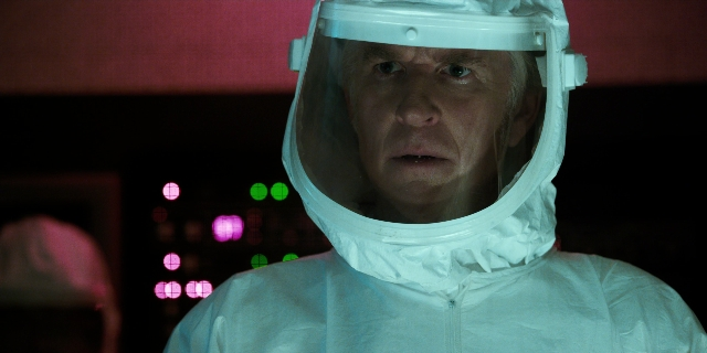 Medium shot frame from Stranger Things — hat, suit, face