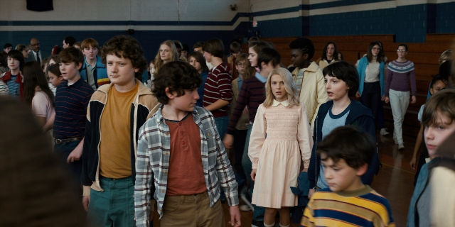 Wide shot frame from Stranger Things — standing, room, dialogue