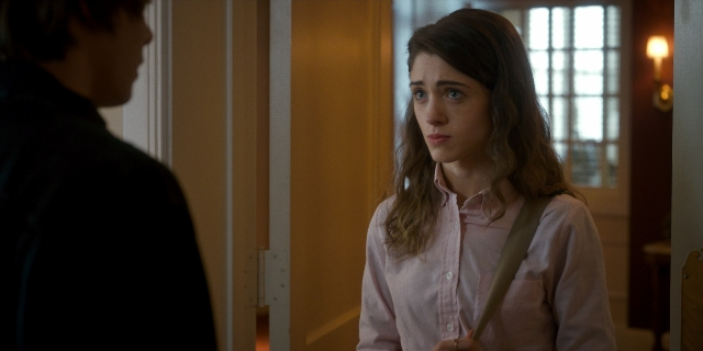 Wide shot frame from Stranger Things — standing, door, hand