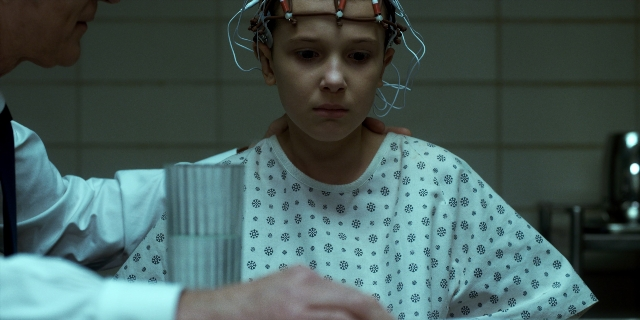Medium shot frame from Stranger Things — standing, room, bed