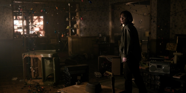 Wide shot frame from Stranger Things — standing, room, furniture
