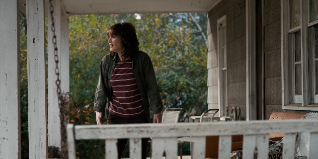 Wide shot frame from Stranger Things — standing, house, shirt
