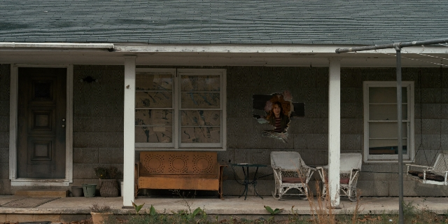 Wide shot frame from Stranger Things — table, door, house