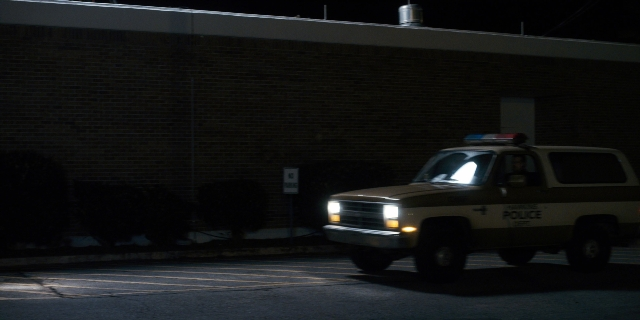 Wide shot frame from Stranger Things — night, truck, wheel