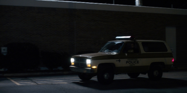Wide shot frame from Stranger Things — night, truck, wheel