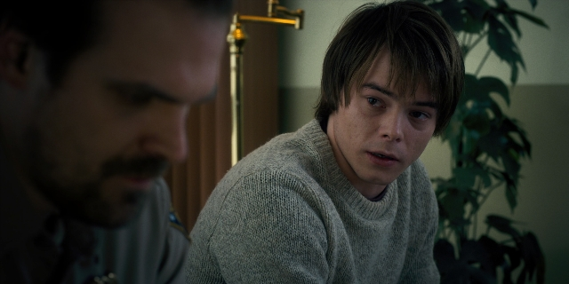 Close-up frame from Stranger Things — sitting, room, table
