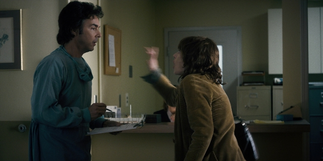 Wide shot frame from Stranger Things — standing, door, coat