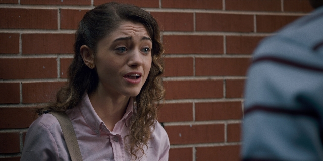 Medium shot frame from Stranger Things — standing, shirt, hair