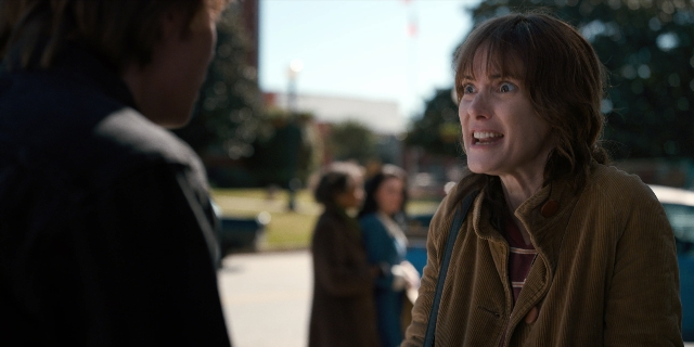 Wide shot frame from Stranger Things — standing, dialogue, jacket