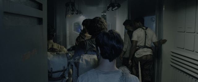 Wide shot frame from The Maze Runner — standing, car, hair