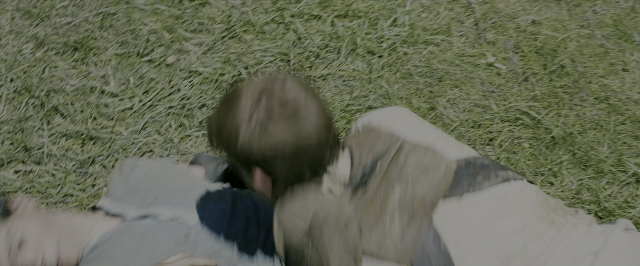 Wide shot frame from The Maze Runner — shirt, person, human head