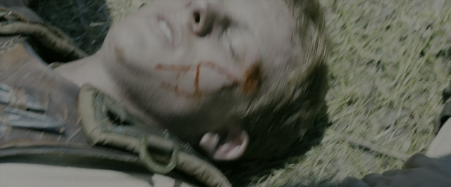 Wide shot frame from The Maze Runner — bed, face, hair