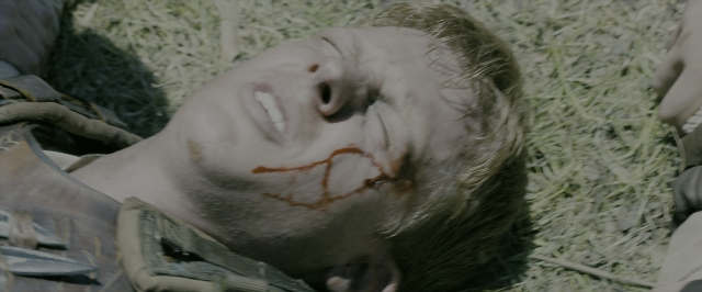 Wide shot frame from The Maze Runner — bed, hat, uniform