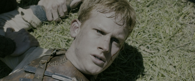 Wide shot frame from The Maze Runner — bed, face, hair