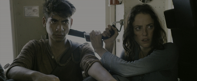 Wide shot frame from The Maze Runner — sitting, hand, shirt