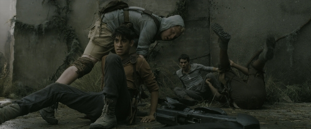 Wide shot frame from The Maze Runner — standing, gun, person