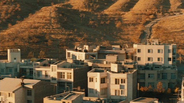 Wide shot frame from Ta'm e guilass — house, window, running