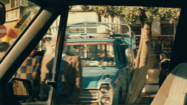 Wide shot frame from Ta'm e guilass — walking, street, mirror