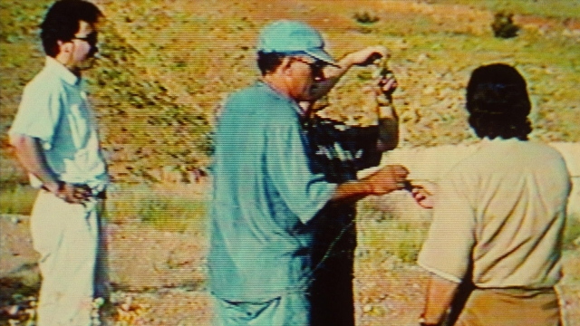Wide shot frame from Ta'm e guilass — standing, hat, person