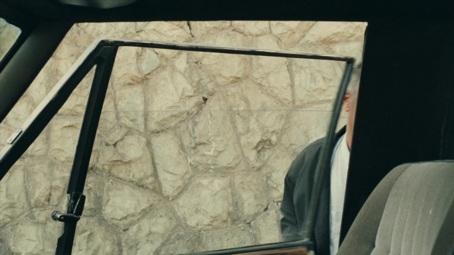 Wide shot frame from Ta'm e guilass — car, glass, window