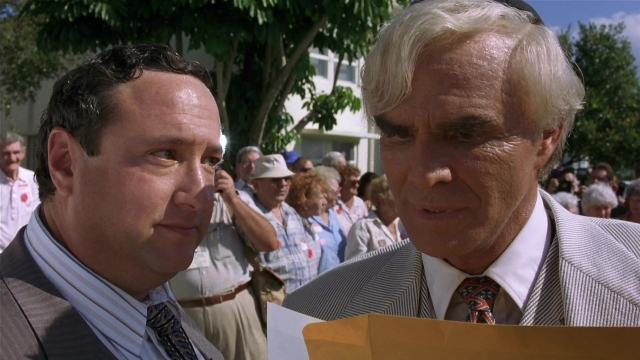 Medium shot frame from Striptease — standing, dialogue, hand