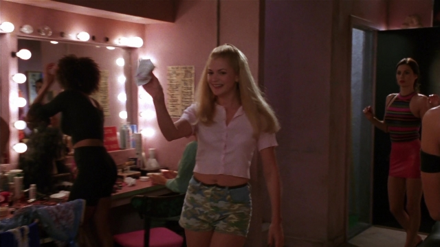Wide shot frame from Striptease — standing, room, table