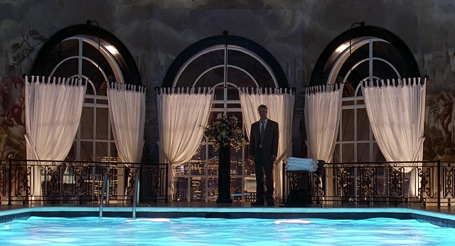 Wide shot frame from Meet Joe Black — standing, room, suit