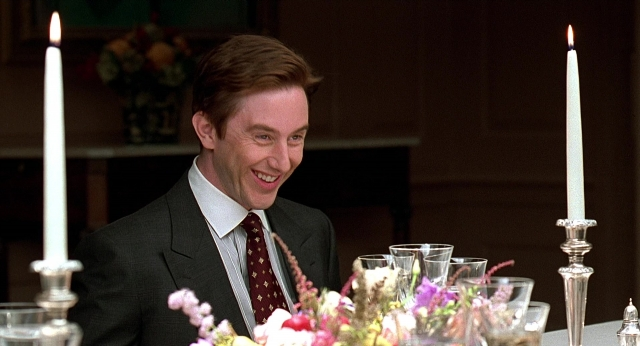 Wide shot frame from Meet Joe Black — sitting, room, table