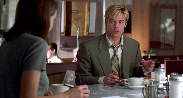 Wide shot frame from Meet Joe Black — sitting, table, suit