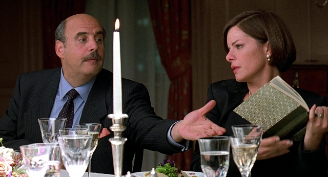 Wide shot frame from Meet Joe Black — sitting, book, room