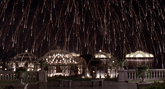 Wide shot frame from Meet Joe Black — night, fountain