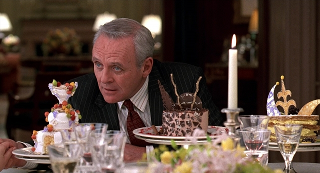 Wide shot frame from Meet Joe Black — sitting, room, table