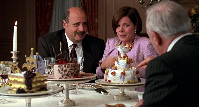 Wide shot frame from Meet Joe Black — sitting, table, suit