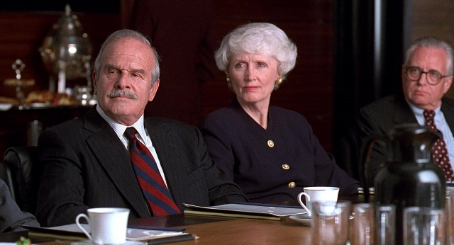 Wide shot frame from Meet Joe Black — sitting, table, suit