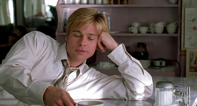Medium shot frame from Meet Joe Black — sitting, kitchen, tie