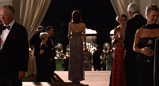 Wide shot frame from Meet Joe Black — dialogue, suit, dress