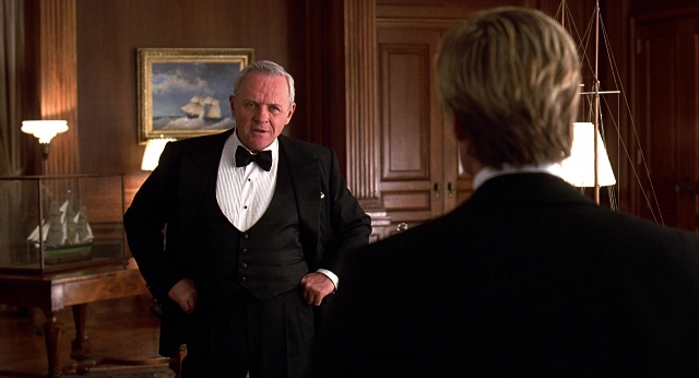 Wide shot frame from Meet Joe Black — standing, room, suit