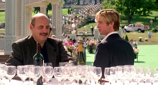Wide shot frame from Meet Joe Black — sitting, walking, table