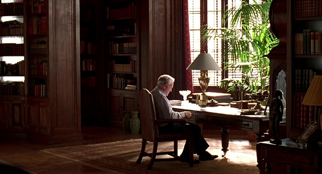 Wide shot frame from Meet Joe Black — sitting, room, table