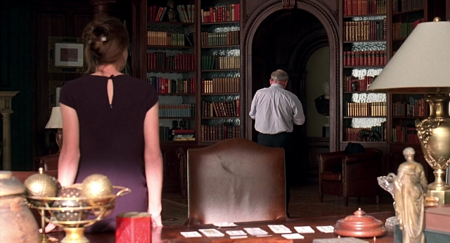 Wide shot frame from Meet Joe Black — standing, room, table