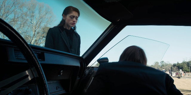 Wide shot frame from Stranger Things — sitting, street, car