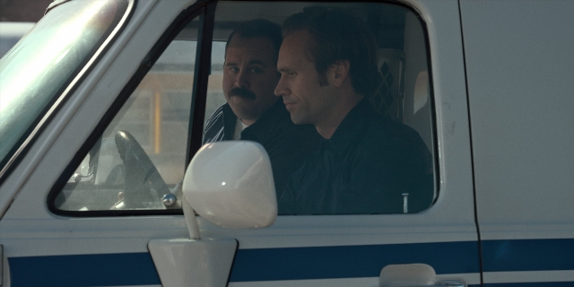Frame from Stranger Things — sitting, mirror, suit