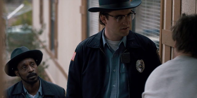 Wide shot frame from Stranger Things — standing, hat, uniform